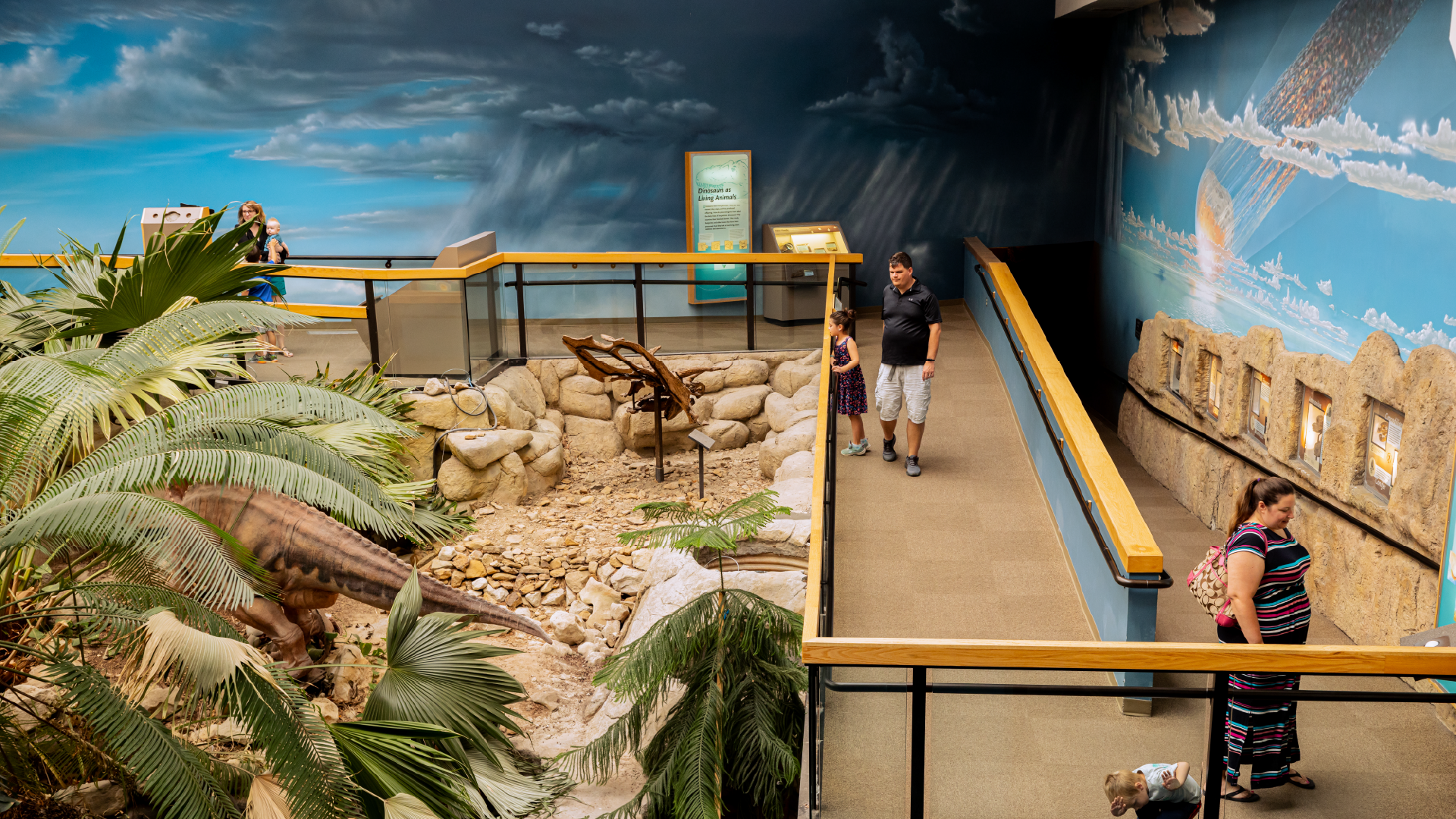 Visitors walking on ramp winding through an exhibition