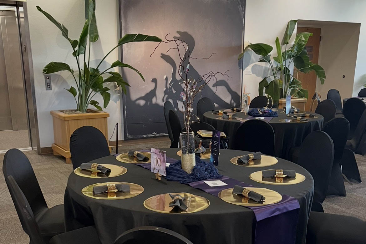 Formal event table set with gold chargers and place settings