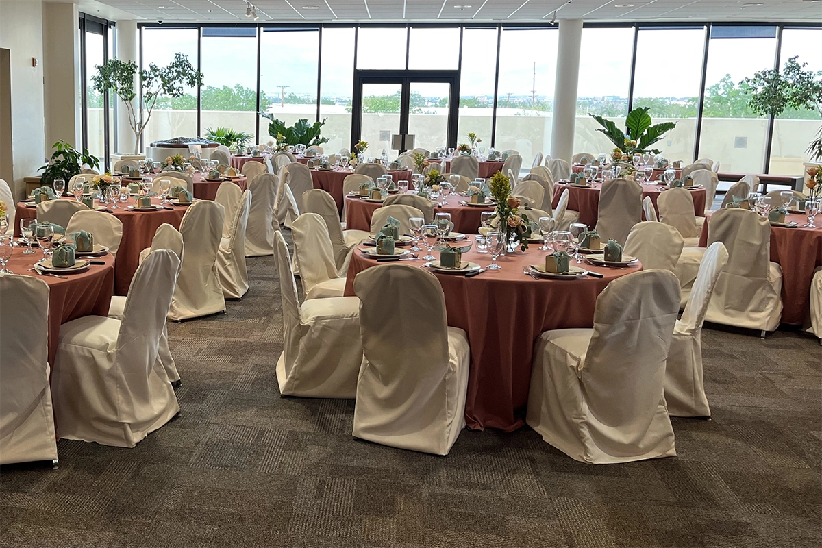 Sandia Room Sandia Room event space set with round tables and floor-to-ceiling windows