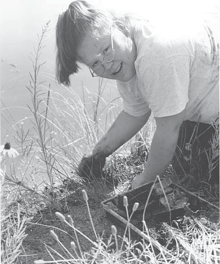 guadalupe_holguin High School student pulling weeds by the shore line of Rio Grande